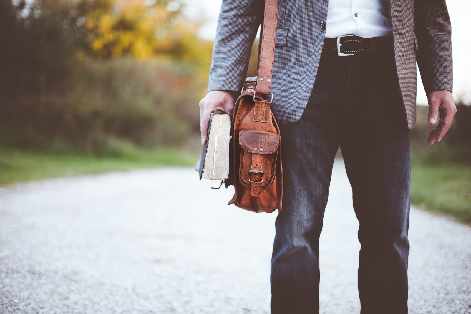 Foto van Ben White man holding book on road during daytime